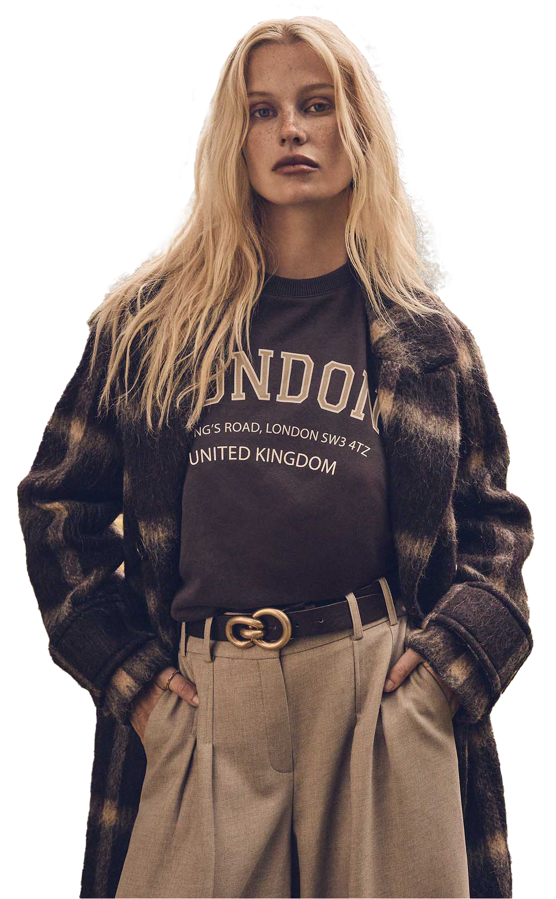 Mannequin portant un sweat London, un manteau à carreaux et un pantalon beige